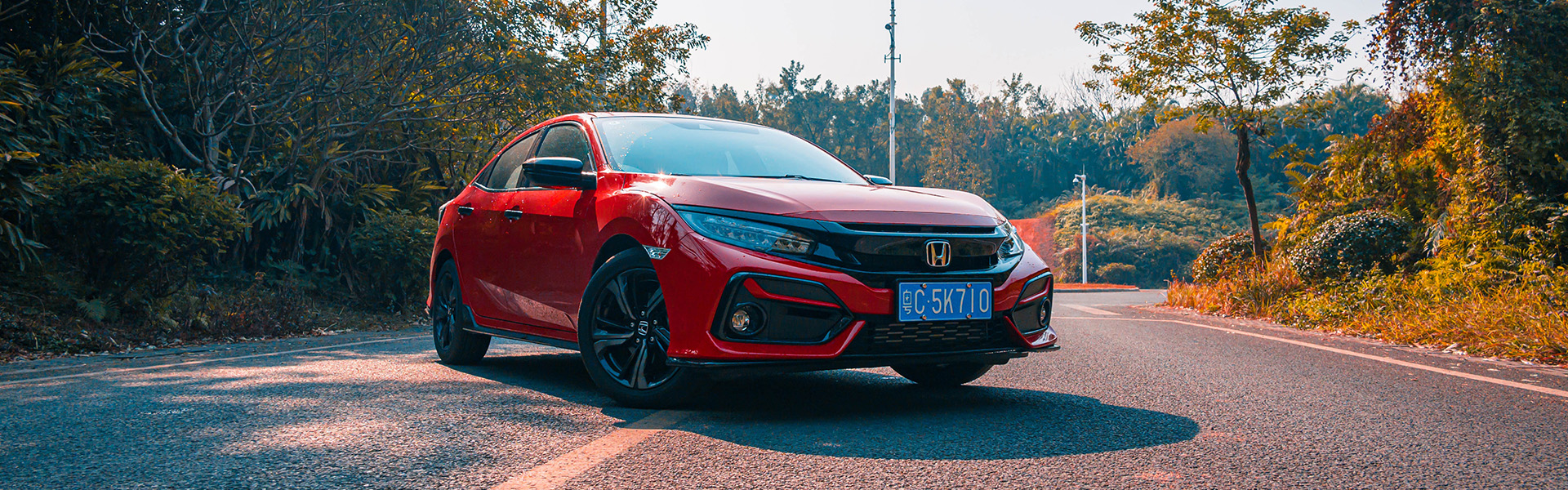 Best of Clinton is a Car Dealership near Elizabethtown, NC | Red Pre-Owned Honda Civic Parked on Road